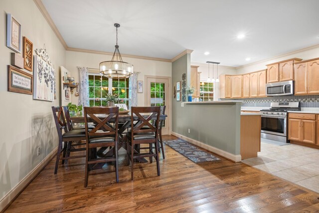 116 Sherrolyn Ct, Burns, TN 37029 - dining space with a chandelier, crown molding, and light wood-style floors