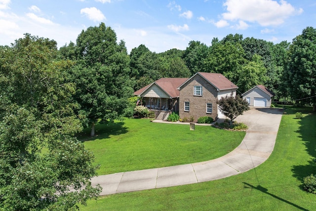 116 Sherrolyn Ct, Burns, TN 37029 - view of front of home with covered porch, a garage, a front yard, an outdoor structure, and a view of trees