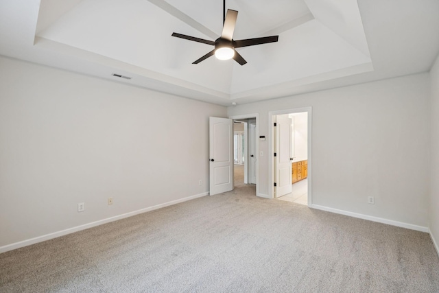 3455 Esquire Dr, Murfreesboro, TN 37130 - unfurnished bedroom featuring a raised ceiling, light carpet, ensuite bath, and a ceiling fan