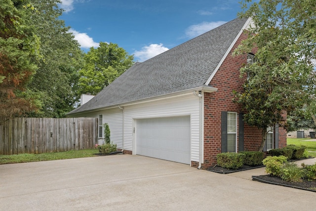 3455 Esquire Dr, Murfreesboro, TN 37130 - view of side of property featuring a shingled roof, driveway, an attached garage, and brick siding