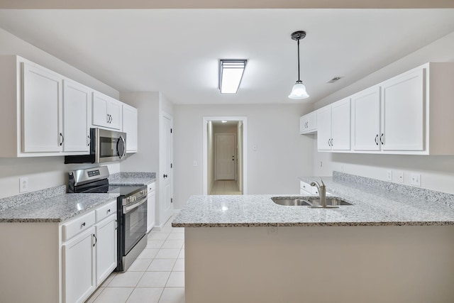 3455 Esquire Dr, Murfreesboro, TN 37130 - kitchen featuring stainless steel appliances, a peninsula, white cabinetry, and light stone counters