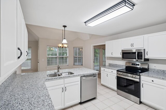 3455 Esquire Dr, Murfreesboro, TN 37130 - kitchen with stainless steel appliances, a chandelier, white cabinets, and light tile patterned floors