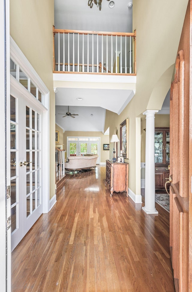 9732 Turnbridge Ct, Brentwood, TN 37027 - entrance foyer featuring decorative columns, a towering ceiling, wood finished floors, ceiling fan, and arched walkways