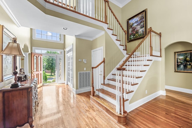 9732 Turnbridge Ct, Brentwood, TN 37027 - foyer featuring a towering ceiling, wood finished floors, stairs, ornamental molding, and arched walkways