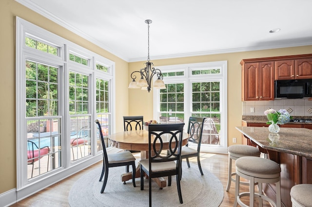 9732 Turnbridge Ct, Brentwood, TN 37027 - dining room with a chandelier, ornamental molding, and light wood-style floors