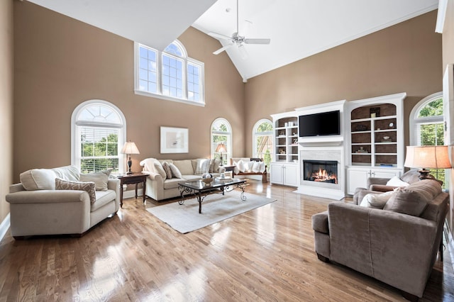 9732 Turnbridge Ct, Brentwood, TN 37027 - living room with high vaulted ceiling, ceiling fan, healthy amount of natural light, a fireplace with flush hearth, and wood finished floors