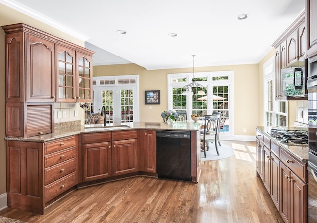 9732 Turnbridge Ct, Brentwood, TN 37027 - kitchen with black dishwasher, light wood finished floors, a peninsula, light stone counters, and crown molding