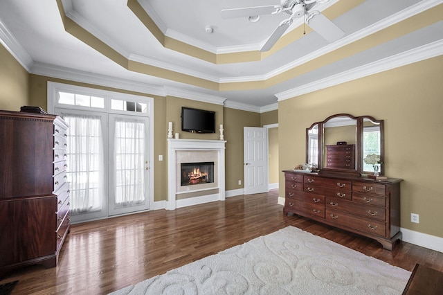 9732 Turnbridge Ct, Brentwood, TN 37027 - bedroom featuring a raised ceiling, a glass covered fireplace, wood finished floors, ornamental molding, and access to outside