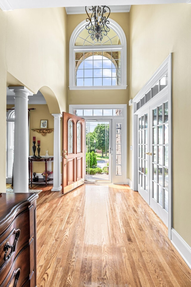 9732 Turnbridge Ct, Brentwood, TN 37027 - foyer with ornate columns, wood finished floors, arched walkways, a high ceiling, and french doors