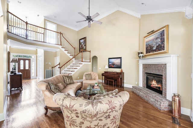 9732 Turnbridge Ct, Brentwood, TN 37027 - living room with wood finished floors, stairs, a ceiling fan, high vaulted ceiling, and a brick fireplace