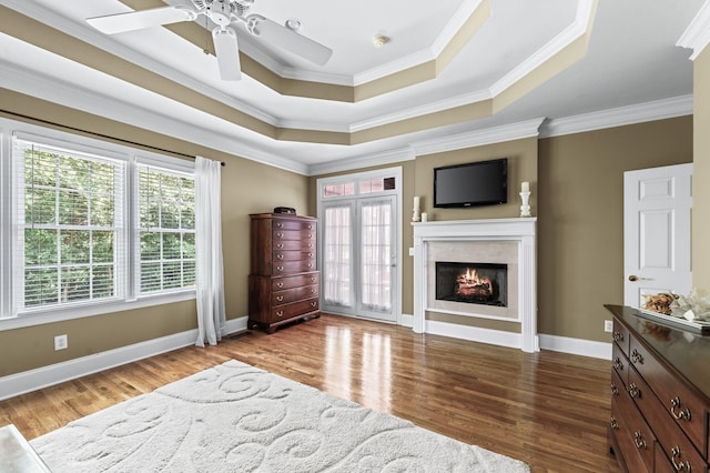 9732 Turnbridge Ct, Brentwood, TN 37027 - bedroom with a raised ceiling, crown molding, wood finished floors, a lit fireplace, and ceiling fan