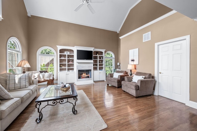 9732 Turnbridge Ct, Brentwood, TN 37027 - living area with crown molding, high vaulted ceiling, wood finished floors, ceiling fan, and a glass covered fireplace