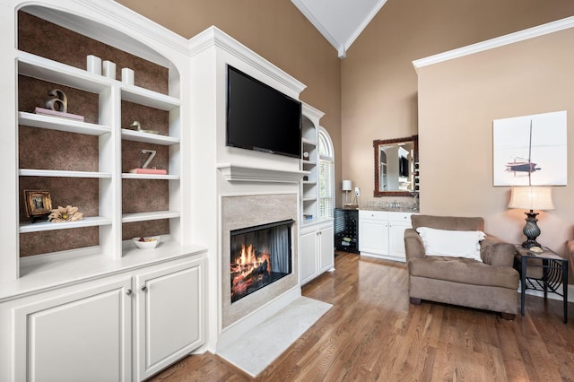 9732 Turnbridge Ct, Brentwood, TN 37027 - living area featuring ornamental molding, a fireplace, wood finished floors, built in features, and high vaulted ceiling