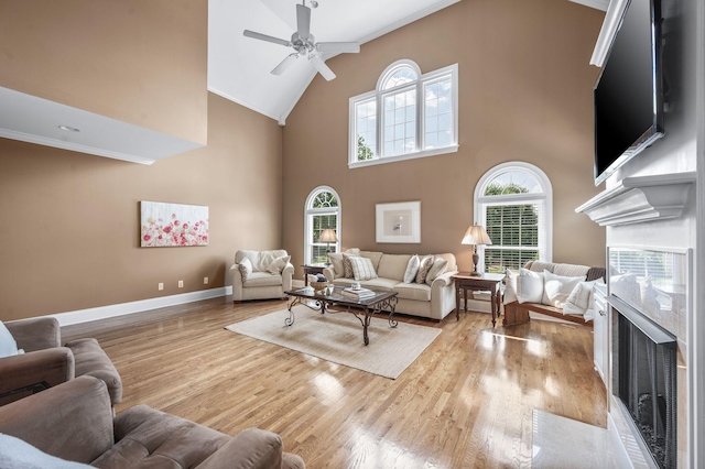 9732 Turnbridge Ct, Brentwood, TN 37027 - living room with a premium fireplace, a ceiling fan, high vaulted ceiling, wood finished floors, and ornamental molding