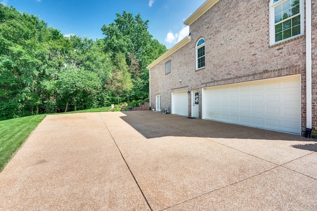 9732 Turnbridge Ct, Brentwood, TN 37027 - view of side of home featuring an attached garage, concrete driveway, and brick siding