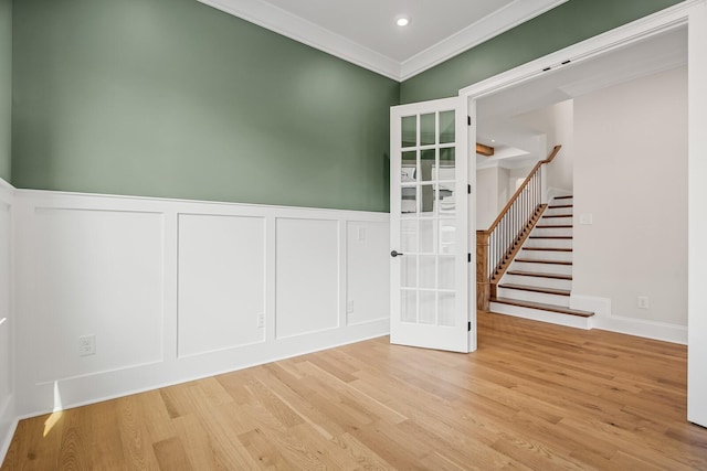 7428 Leelee Dr, Franklin, TN 37064 - spare room featuring a decorative wall, french doors, light wood finished floors, stairs, and a wainscoted wall