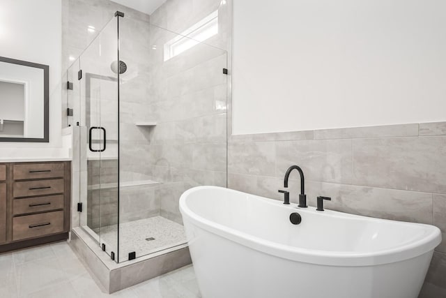 7428 Leelee Dr, Franklin, TN 37064 - bathroom featuring a stall shower, a freestanding tub, tile walls, vanity, and a wainscoted wall