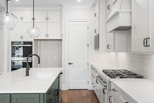 7428 Leelee Dr, Franklin, TN 37064 - kitchen featuring green cabinetry, appliances with stainless steel finishes, backsplash, dark wood-type flooring, and white cabinetry