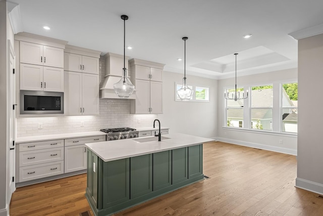 7428 Leelee Dr, Franklin, TN 37064 - kitchen with stainless steel microwave, tasteful backsplash, a tray ceiling, green cabinets, and a chandelier