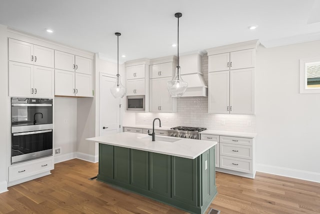 7428 Leelee Dr, Franklin, TN 37064 - kitchen featuring appliances with stainless steel finishes, white cabinetry, light countertops, backsplash, and recessed lighting