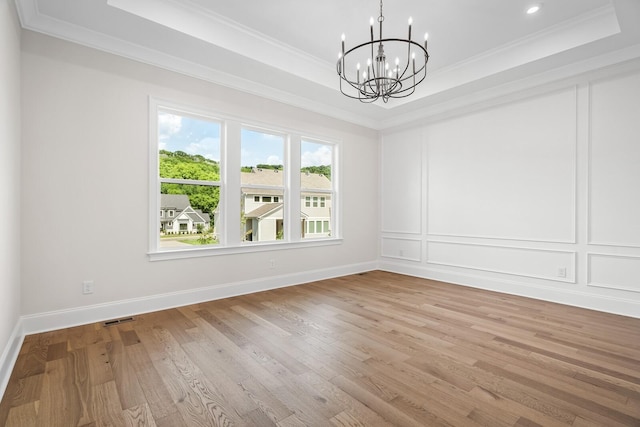 7428 Leelee Dr, Franklin, TN 37064 - spare room featuring a raised ceiling, a chandelier, crown molding, light wood-type flooring, and recessed lighting