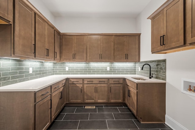 7428 Leelee Dr, Franklin, TN 37064 - kitchen with tasteful backsplash, dark tile patterned flooring, and brown cabinets