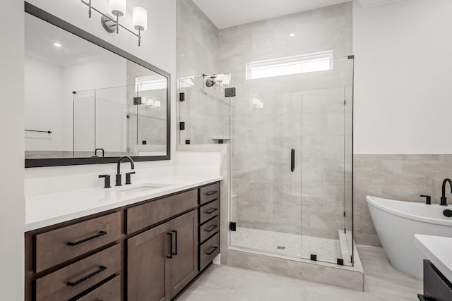 7428 Leelee Dr, Franklin, TN 37064 - bathroom with vanity, a shower stall, a freestanding bath, and tile walls