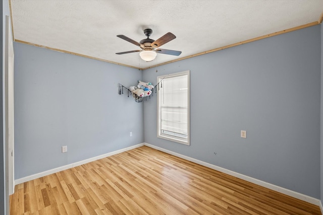 3135 Mullins Rd, Byrdstown, TN 38549 - unfurnished room featuring wood finished floors, ceiling fan, crown molding, and a textured ceiling