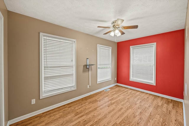 3135 Mullins Rd, Byrdstown, TN 38549 - empty room featuring wood finished floors, a ceiling fan, and a textured ceiling