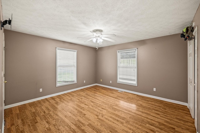 3135 Mullins Rd, Byrdstown, TN 38549 - unfurnished room featuring light wood-style flooring, a ceiling fan, and a textured ceiling