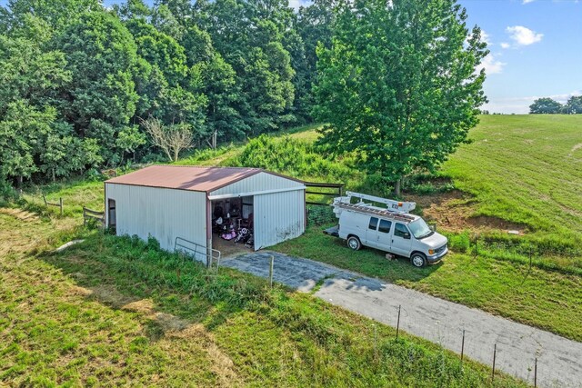 3135 Mullins Rd, Byrdstown, TN 38549 - view of pole building with asphalt driveway and a lawn