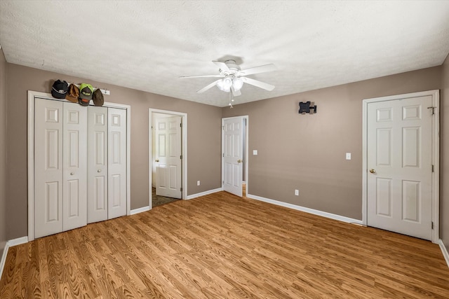 3135 Mullins Rd, Byrdstown, TN 38549 - unfurnished bedroom with light wood-style floors, ceiling fan, a closet, and a textured ceiling