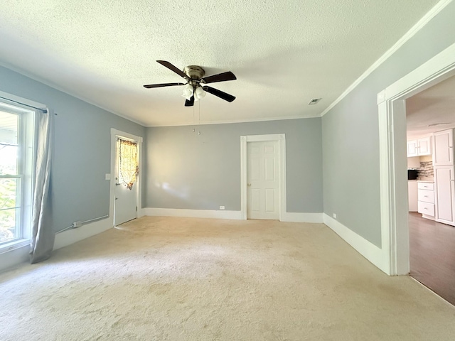 2844 Jarman Hollow Rd, Palmyra, TN 37142 - empty room featuring healthy amount of natural light, ceiling fan, a textured ceiling, light colored carpet, and crown molding