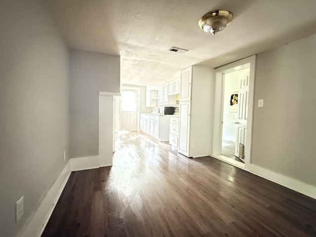 2844 Jarman Hollow Rd, Palmyra, TN 37142 - unfurnished living room with dark wood finished floors and a textured ceiling