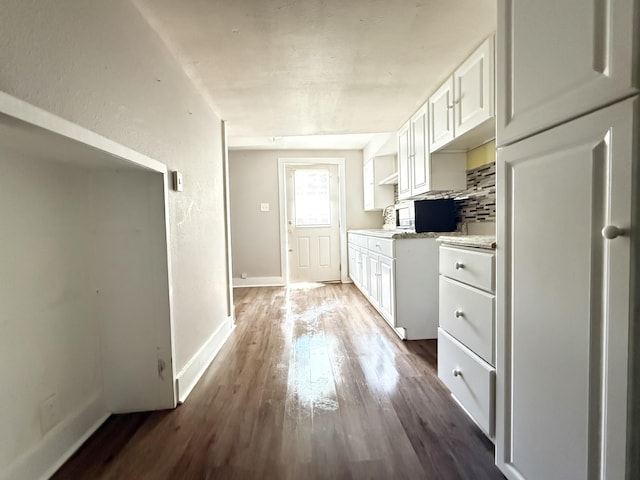2844 Jarman Hollow Rd, Palmyra, TN 37142 - kitchen with wood finished floors, light countertops, white cabinetry, open shelves, and backsplash