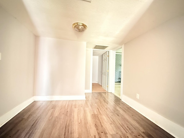 2844 Jarman Hollow Rd, Palmyra, TN 37142 - unfurnished room featuring wood finished floors, a wall of windows, and a textured ceiling