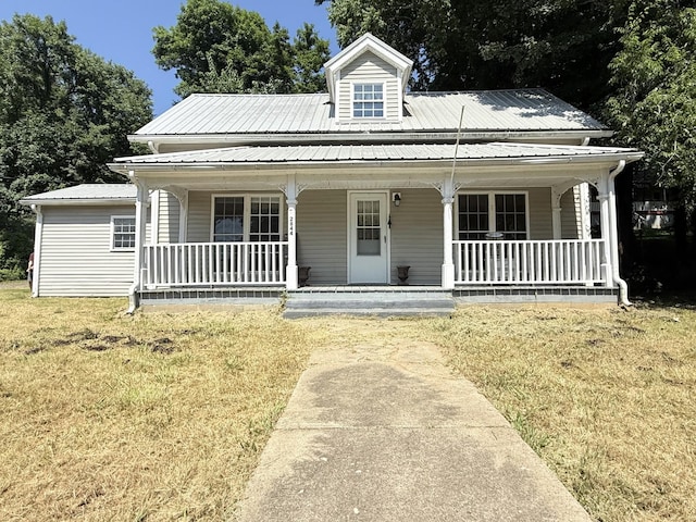 2844 Jarman Hollow Rd, Palmyra, TN 37142 - view of front of house with a front lawn, a metal roof, and covered porch