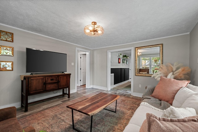 909 W 1st St, Dickson, TN 37055 - living area with wood finished floors, a textured ceiling, ornamental molding, and a chandelier