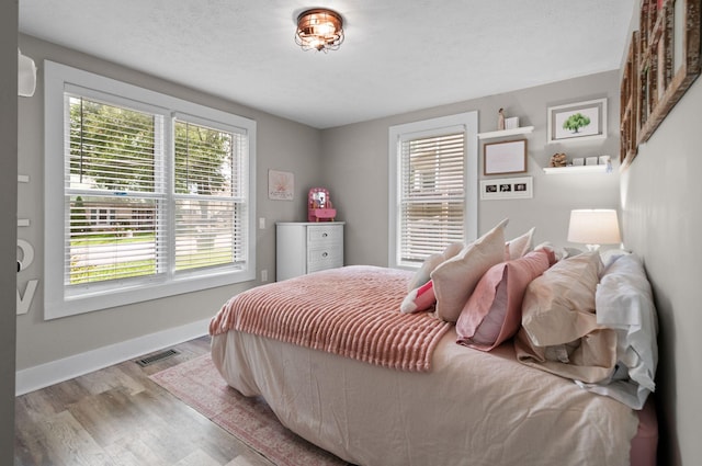 909 W 1st St, Dickson, TN 37055 - bedroom with wood finished floors and baseboards