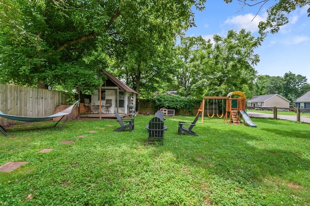 909 W 1st St, Dickson, TN 37055 - fenced backyard with a playground and a wooden deck