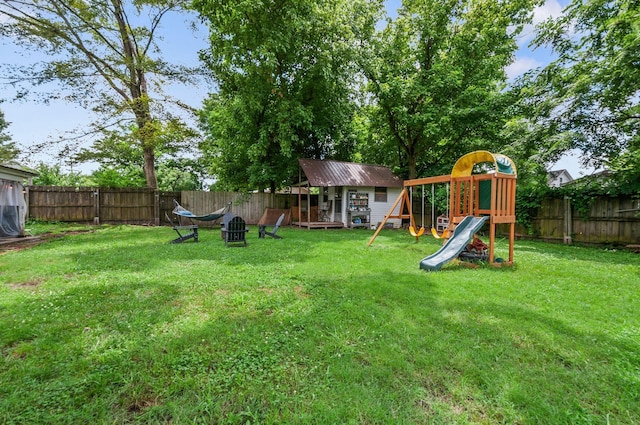 909 W 1st St, Dickson, TN 37055 - fenced backyard with a playground and an outdoor structure