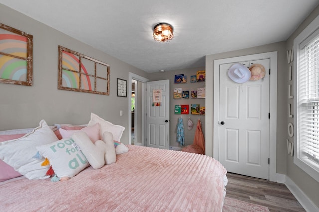 909 W 1st St, Dickson, TN 37055 - bedroom featuring wood finished floors and multiple windows