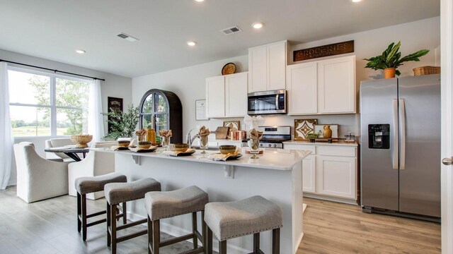 4910 Mowbray Way, Murfreesboro, TN 37129 - kitchen featuring stainless steel appliances, white cabinetry, a kitchen breakfast bar, a kitchen island with sink, and recessed lighting