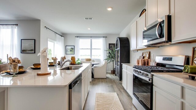 4910 Mowbray Way, Murfreesboro, TN 37129 - kitchen featuring stainless steel appliances, light countertops, white cabinetry, light wood finished floors, and recessed lighting