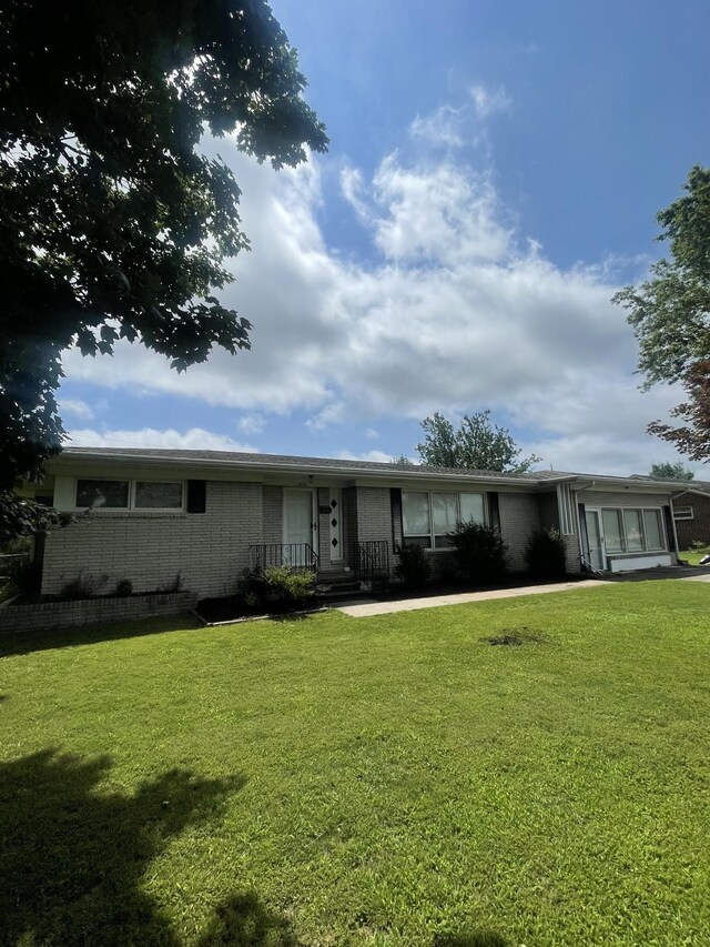 1212 Poplar Dr, Lawrenceburg, TN 38464 - view of front of home with brick siding and a front lawn