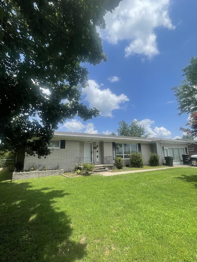 1212 Poplar Dr, Lawrenceburg, TN 38464 - view of front of home featuring brick siding and a front lawn