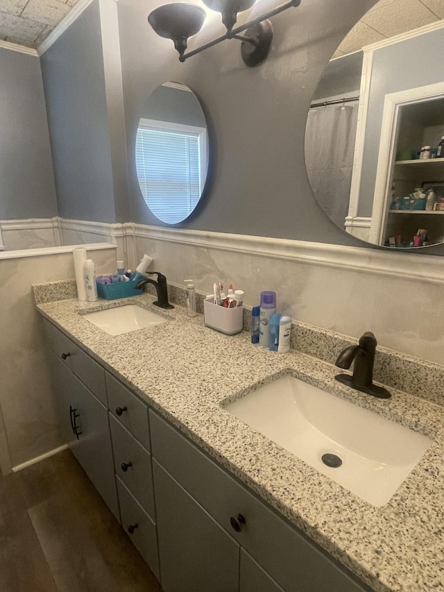 1212 Poplar Dr, Lawrenceburg, TN 38464 - bathroom with double vanity, crown molding, and a wainscoted wall