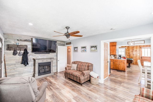 305 Bryant St, Watertown, TN 37184 - living area featuring a fireplace, light wood-style flooring, a ceiling fan, wood walls, and recessed lighting