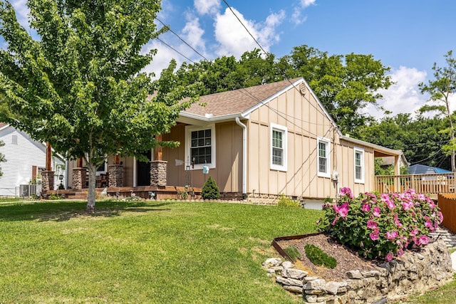 305 Bryant St, Watertown, TN 37184 - view of front of house featuring board and batten siding, a front yard, covered porch, and a shingled roof