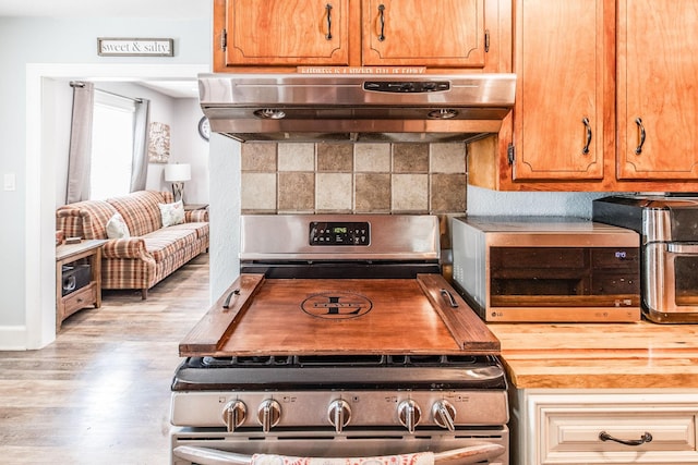 305 Bryant St, Watertown, TN 37184 - kitchen featuring exhaust hood, stainless steel electric range, wood finished floors, and tasteful backsplash